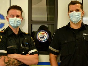 Joey Renaud, acting commander, Perth County Paramedic Services (left), and paramedic Rick Vandenberg next to a new decal paramedics are adding to their vehicles this week. The symbol includes the words ‘inclusive,’ ‘accepting,’ and ‘welcoming’ and is part of an effort paramedics are making to ensure everyone who needs emergency services feels safe and respected. 
Galen Simmonds/Stratford Beacon Herald