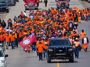 Members of Tsuutina Nation west of Calgary march on June 7 in memory of the 215 unmarked graves found at a residential school in Kamloops. GAVIN YOUNG/POSTMEDIA