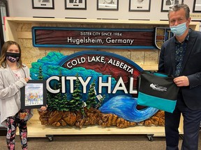 Mayor Craig Copeland hands out an award to Riley, one of the winners of the Public Works Week colouring contest. CITY OF COLD LAKE/FACEBOOK
