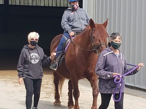 Jen, aboard Sienna, a big red horse, enjoyed a ride recently at PRANCE, the therapeutic equestrian centre in Port Elgin. Volunteers Paula Clark (leading) and Bev Turner also enjoyed the outting. [SUPPLIED]