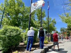 Canmore Mayor John Borrowman raises of the Treaty 7 flag with Elder Buddy Wesley at the Civic Centre on June 21, 2021. Photo Marie Conboy/ Postmedia.