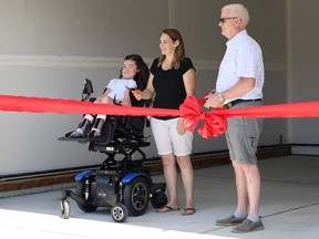 Pyper Whitecotton (left), her mother Heather Forsyth, and Rococo Homes Founder and President Rick Lystang welcomed members of the community to a ribbon cutting ceremony at Whitecotton and Forsyth's new Aspenglen Drive home on Wednesday, Jun. 23, 2021. Photo by Rudy Howell/Postmedia.