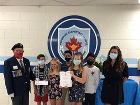 Northport Elementary School Grade six graduates Zander Alpaugh (second from left), Emma Redmond, Zuhayr Abbas, Mya Downey, Shrey Desai and teacher, Ms. Andrea Anions, accepted a certificate and a $150 cheque from Royal Canadian Legion Branch 340 president Robert Harrison June 25 at the Port Elgin school. The students' video earned third place, province wide, in the annual Legion Remembrance Day contest. [Royal Canadian Legion Branch #340]
