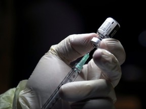 A health-care worker prepares to administer a Pfizer/BioNTEch coronavirus disease (Covid-19) vaccine.