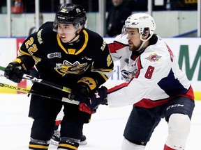 Windsor Spitfires' Connor Corcoran (8) checks Sarnia Sting's Justin O'Donnell (22) in the first period at Progressive Auto Sales Arena in Sarnia, Ont., on Sunday, Jan. 26, 2020. Mark Malone/Chatham Daily News/Postmedia Network