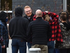 Pastor James Coates walks out of the Remand Centre greeted by a group of supporters after being released from the facility late Monday afternoon in Edmonton, March 22, 2021. A judge has thrown out an application from Coates seeking to have COVID enforcement actions at the Parkland County church deemed unconstitutional.