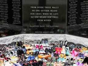 Children's shoes have been placed at the Walpole Island First Nation monument dedicated to the children from the community who attended Indigenous residential schools. Dozens of pairs have been placed at the monument in memory of the 215 children's bodies discovered in a mass grave at a former residential school in Kamloops, B.C. Photo taken in Walpole Island, Ont., on Monday, May 31, 2021. (Mark Malone/Postmedia Network)