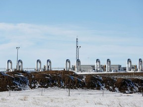 A TC Energy pump station sits behind mounds of dirt from the Keystone XL crude oil pipeline as it lies idle near Oyen, Alberta, February 1, 2021.