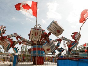 Riders take in the Orbiter ride on a windy day at K-Days in Edmonton, on Thursday, July 25, 2019.  On June 1, Northlands announced K-Days was cancelled for this summer.