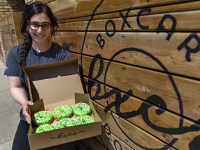 Joan Omar of Boxcar Donuts shows green sprinkled doughnuts the shop is selling to raise money in the name of the London family struck by a truck while out for a walk on Sunday night in London. Police say the driver targeted the family in the collision that killed four members and injured a fifth because they were Muslim. The #OurLondonFamily doughnuts sell for $3.25 each and proceeds are donated to a GoFundMe page created with permission of the family. (Mike Hensen/The London Free Press)