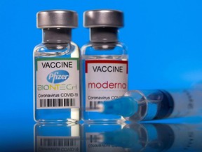 Vials with Pfizer-BioNTech and Moderna coronavirus disease vaccine.