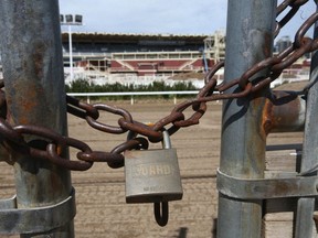 A padlock is shown on a gate leading from the barns area to the backstretch of the track at the infield area at the Stampede grounds in Calgary on Thursday, May 27, 2021. Suffering from a $26.5-million loss on its operations from last year's cancelled event and beset with fiscal concerns about a truncated 2021 Stampede, the annual cowboy bash is asking the city to waive, rein or amend agreements on its debt servicing and credit requirements.