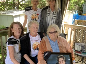 The Sevier family – Sherril Sevier, holding a photo of her husband Jack and herself, and daughters Jodie Sevier, left, Robin Bond and (back) Shantell McKelvie and Troy Antonie, along with Ray Sevier and Lacey Sevier, who both live out of town, say justice has been denied for their father, who died two weeks after a vicious beating in a home invasion on their quiet street.