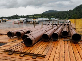 Pieces of the Trans Mountain Pipeline project sit in a storage lot outside of Abbotsford, British Columbia on June 6, 2021. The Trans Mountain Pipeline System is a pipeline that conveys crude and refined oil from Alberta to the coast of British Columbia.