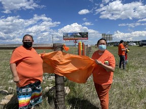 Teddy bears line the Trans Canada Highway as far as the eye can see near the Highway 40 overpass on June 4. Amanda Goodstoney (left) a crisis support worker with Morley health, one of the organizers of the ceremony on Friday, spoke about the trauma her mother experienced as a survivor of the residential school in Morley. Photo Marie Conboy/ Postmedia.