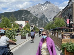 The sunflowers bloom on Banff Ave last week as larger crowds enter Banff last weekend. The relaunch plan, labelled "Open for Summer" by the provincial government, is primarily tied to vaccination rates. Hospitalizations due to COVID also factor in to the first two stages, which Kenney said reflects a "cautious" approach. Photo Marie Conboy/ Postmedia.