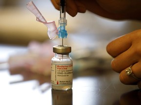 Nurse Brenda Lotakoun draws a dose of the Moderna COVID-19 vaccine March 23 in Toronto. (Cole Burston/Getty Images)