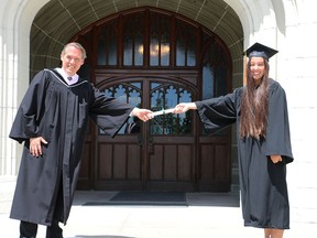 Albert College Head of School Mark Musca presents Belleville's Ruby Kawam with her diploma during convocation ceremonies held Saturday with COVID-19 restrictions. Kawam was awarded the Howard Award for the finest representative female student of Albert College, and the Governor GeneralÕs Academic Medal for the highest academic average in Grades 11 and 12. SUBMITTED PHOTO