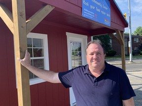 Scott Witten, of The Red Shed Co., stands outside a shed in the parking lot of the Dairy Queen  on King George Road that is available for use by charities.