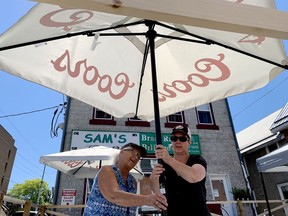 Sam Major, left, owner of Sam's Brass Rack on Perth Street, and her daughter, manager Trish Tye, prepare the establishment's patio on Thursday for Friday morning's Stage One reopening. (RONALD ZAJAC/The Recorder and Times)