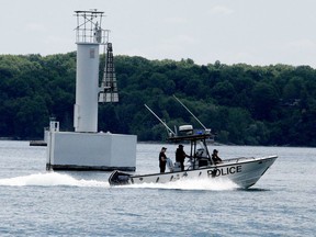 Members of the Ontario Provincial Police's Leeds and Grenville Marine Unit pass a range marker on Butternut Bay as they continue their search for a missing 27-year-old man on Sunday morning. (RONALD ZAJAC/The Recorder and Times)