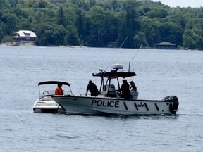 OPP Marine Unit members spoke to a pleasure boater on Butternut Bay as they continued their search for a missing man on Sunday. (RONALD ZAJAC/The Recorder and Times)