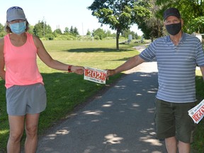 Kathy Easter receives her commemorative bib from Canada Day Run/Walk organizer Ed Eby of the Brockville Road Runners Club. Participants in the food bank fundraiser will leave their front doors at 10 a.m. on Thursday morning and run or walk in their own communities.
File photo/The Recorder and Times