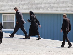 Churchgoers arrive for a service at the Old Colony Mennonite Church near Wheatley on Sunday, June 6. Mark Malone
