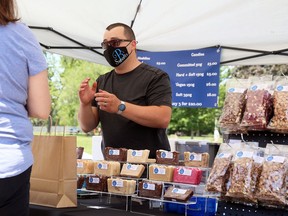 Kylle Benoit of B's Sweets serves a customer during the Chatham Armoury Outdoor Spring Market on Saturday, June 5. Mark Malone/Postmedia Network