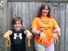 Hayley Sowinski, 12, and her brother Zach, 8, display some of the bracelets she's making to sell as a fundraiser with all the proceeds to be donated to the Indian Residential School Survivors Society. Ellwood Shreve/Chatham Daily News