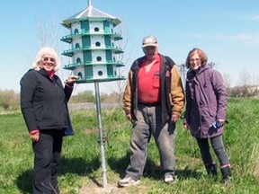 Anne Melady (left), Bert Vorstenbosch, Sr. and Rita Christie are seen with a purple martin house they erected at the West Perth Wetlands last month. SUBMITTED