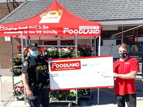 OPP Sgt. Russ Nesbitt and Dave Corrie, with a $1,000 cheque for Special Olympics. Handout