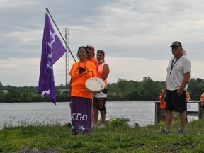 Participants were handed flowers to put in the St. Lawrence River, in order to commemorate the 215 victims. Pictured is Georgina Lazore, who became a local symbol of perseverance against residential schools. Photo taken on Saturday June 5, 2021 in Cornwall, Ont. Francis Racine/Cornwall Standard-Freeholder/Postmedia Network