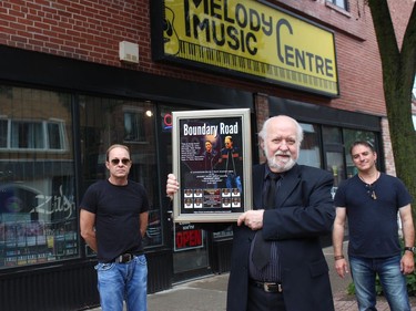 John McIntosh (left) and Pete Nichol (right) presented a Boundary Road plaque to Melody Music Centre owner Stephen Summers. Photo on Saturday, June 26, 2021, in Cornwall, Ont. Todd Hambleton/Cornwall Standard-Freeholder/Postmedia Network