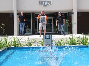 John McIntosh (left) and Pete Nichol have been making a pretty big splash lately, and last weekend they presented a Boundary Road plaque to the city, to acting mayor Todd Bennett. Photo on Sunday, June 27, 2021, in Cornwall, Ont. Todd Hambleton/Cornwall Standard-Freeholder/Postmedia Network