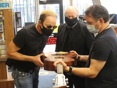 John McIntosh (left) and Pete Nichol (right) checking out a guitar, with Melody Music owner Stephen Summers. Photo on Saturday, June 26, 2021, in Cornwall, Ont. Todd Hambleton/Cornwall Standard-Freeholder/Postmedia Network