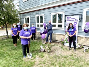 Members of the World Elder Abuse Awareness Day committee along with councillor Susan Flowers and Mayor Jeff Genung plant a lilac tree in front of the FCSS building June 15 in the latest round of an annual tradition commemorating the date. Patrick Gibson/Cochrane Times