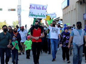 People walk down Franklin Avenue to the provincial building in a march against Islamophobia on Saturday, June 19, 2021. Laura Beamish/Fort McMurray Today/Postmedia Network
