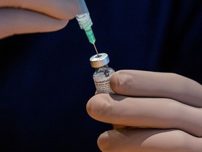 A healthcare worker prepares a dose of the Pfizer/BioNTech coronavirus disease (COVID-19) vaccine, which was authorized by Canada to be used for children aged 12 to 15, at Woodbine Racetrack pop-up vaccine clinic in Toronto, Ontario, Canada May 5, 2021.