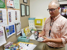 Ian Reich, manager of the harm reduction program at the Grey Bruce Health Unit, demonstrates how to use a naloxone kit at their headquarters in Owen Sound in this file photo from July, 2019. File photo/Postmedia Network