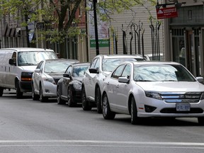 Vehicles parked on a downtown Kingston street.