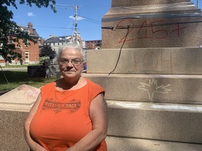 Bonita Lawrence, author of Decolonizing Antiracism and a former professor at Queen's University, stands in front of the Sir John A. Macdonald statue in City Park in Kingston on Wednesday. Lawrence led a discussion about Sir John A. Macdonald and the evolution of the Indian Act in the park in the afternoon.