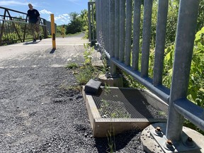 A turtle nest protector sits next to the bridge on the K&P Trail in the area where five nests were raided by poachers earlier this week in Kingston, Ont. on Wednesday, June 23, 2021. 
Elliot Ferguson/The Whig-Standard/Postmedia Network