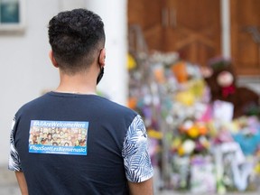 A man pays his respects at the London Muslim Mosque during the multi-faith march to end hatred, after a man driving a pickup truck struck and killed four members of a Muslim family in London on June 6.