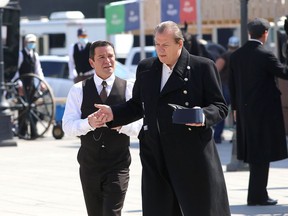 Yannick Bisson, left, in a scene from Murdoch Mysteries filmed at Springer Market Square on June 2 with actor Thomas Craig, who plays Inspector Brackenreid in the show.