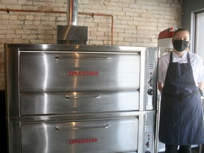 White Squirrel Bakery owner Victoria Allen stands beside the custom made oven in her new bakery opening at 386 Main Street in Exeter.