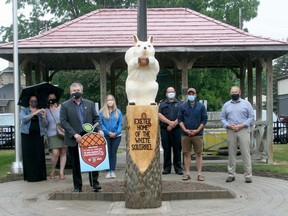 A new initiative in Exeter called the White Squirrel Experience launched June 18. Visitors downtown can download an app which will lead them to various stops through town. The first stop is at the downtown parkette, which features a new white squirrel carving. From left are Exeter BIA board chair Tira Wootton, BIA manager Laura Connolly, South Huron Mayor George Finch, BIA member Leanne Wiseman, South Huron director of fire and community services Jeremy Becker, white squirrel carver Colin Brown and South Huron CAO Dan Best.