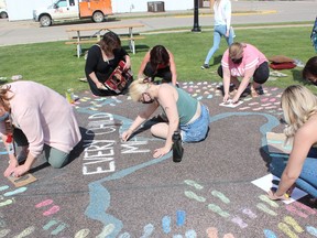 Members of Reconciliation Nipawin spent their afternoon on June 1 tracing chalk outlines of children's footprints with the goal of one set of footprints for every child found at the Kamloops School recently. Photo Susan McNeil.