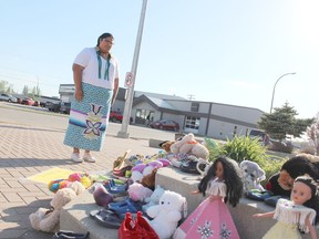 Deeandra Stonestand looks at the shoes and teddy bears place at Melfort City Hall last week after she decided to start a memorial herself in honour of the discovery of 215 graves of children at the Kamloops Residential School recently. Photo Susan McNeil.