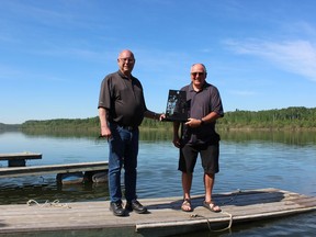 Lyle Hosler stands with MLA Fred Bradshaw, who is also head of the Water Security Agency. Hosler was given an award for engineering work on water flows in the Qu’Appelle River area that helped increase the fish populations there. Photo Susan McNeil